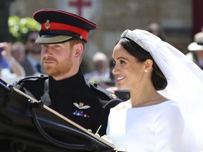 Britain's Prince Harry and his wife Meghan Markle leave after their wedding ceremony, at St. George's Chapel in Windsor Castle in Windsor, near London, England, Saturday, May 19, 2018