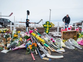 Rocky Salisbury of Nipawin sets up crosses at the intersection of Highway 35 and Highway 335, where the Humboldt Broncos' bus crashed on April 6.