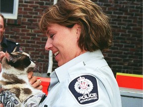 Const. Rhonda Sargent seen in a 1999 file photo. She was returning Coffee the cat to Donna Carleton after it was pulled from an 80 foot tree.