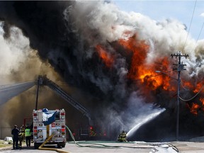 Emergency crews battle a blaze that broke out near Wagner Road and 83 Street in Edmonton on Saturday, May 5, 2018.