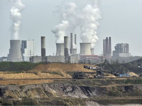 In this April 3, 2014 file photo giant machines dig for brown coal at the open-cast mining Garzweiler in front of a power plant near the city of Grevenbroich in western Germany. Allianz says it will stop insuring coal-fired power plants and coal mines as part of its contribution to combating climate change. "If you don't have policies that underpin the number that's been put in Paris, you've got nothing to drive progress," said Elina Bardram, a European Commission official who's head of the EU delegation at the talks in Bonn.