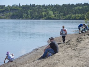 People gather on the bank of the North Saskatchewan river on a warm spring Sunday to enjoy the peacefulness on May 27, 2018 in Edmonton.