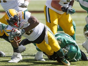 Saskatchewan Roughriders tackle Edmonton Eskimos C.J. Gable (2) during first half CFL pre-season action in Edmonton on Sunday May 27, 2018.