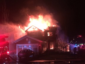 Flames erupt from the top of a home on Applewood Way, just off Cloverbar Road, as fire crews respond to a blaze that demolished a local home in Aspen Trails.

Photo courtesy Dani Desjardines