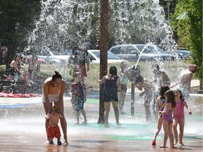 People enjoy the Kinsmen Spray Park on Tuesday, May 22, as temperatures soared to near 30 C in Edmonton.