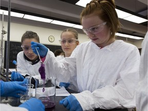 Ava Gustafson,(left) Samantha Boychek (middle) and Bailey Anderson (right) from Ardrossan Elementary School form a mixture that is cross-linking polymers during an experiment on Tuesday, Feb. 20, 2018  in Edmonton.  Roughly 600 schoolgirls from the Edmonton area are learning about science in the University of Alberta labs at the annual CHOICES Conference, presented by the U of A-based Women in Scholarship, Engineering, Science and Technology (WISEST) program.