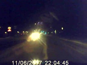 A still image from Jeff McLenaghan's dashcam video showing an oncoming Alberta Sheriff patrol car he said was displaying its high beams. Flashing the motorist to remind him he'd left his brights on resulted in McLenaghan receiving a $155 ticket from the Sheriff in High River, Alta. on Monday, Nov. 6, 2017. Courtesy Jeff McLenaghan