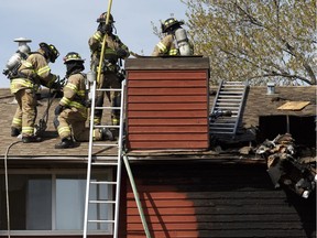 Edmonton Fire Rescue Services firefighters mop up a fire in a unit at 4707 126 Avenue in Edmonton, on Sunday, May 6, 2018. Photo by Ian Kucerak/Postmedia