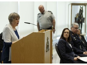 Carolyn Goard, left, director of program and services with the Alberta Council of Women's Shelters, speaks as the organization launches a new Inventory of Promising Practices, developed as part of the Safety from Domestic Violence project, during a news conference at RCMP K Division Headquarters in Edmonton, on Friday, May 11, 2018.