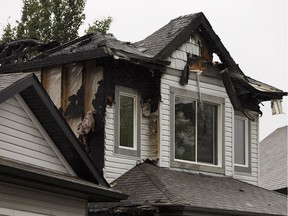 One of three homes heavily damaged in an overnight fire is seen on Melrose Crescent Southwest in Edmonton on Wednesday, May 30, 2018.