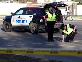 Investigators probe the scene of a pedestrian collision at 31 Street and 38 Avenue on the evening of Tuesday, May 8, 2018.