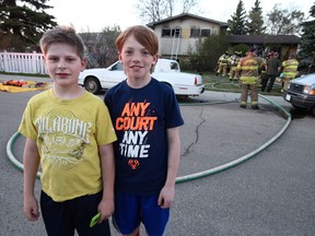 Rieley McGauley, left, 12, and Jonathan Wesselink, 10, were the first to spot a house fire at 15922 88A Ave. and ran home to raise the alarm on Saturday, May 12, 2018.
