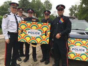 Edmonton Police Service members, including Supt. Brad Doucette (left), ahead of the 2017 Edmonton Pride Parade.