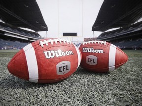 New CFL balls are photographed at the Winnipeg Blue Bombers stadium in Winnipeg Thursday, May 24, 2018. CFL quarterbacks, receivers and running backs players have spent training camp adapting to the new ball introduced for the 2018 season. The new version has harder leather and is minutely larger around than the previous ball. Some players notice a difference, but others don't.