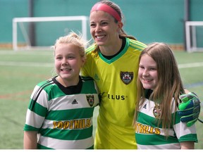 Calgary Foothills FC Goalkeeper Stephanie Labbè poses with supporters in Calgary on Saturday, March 17, 2018 following a friendly match against University of Lethbridge Pronghorns.