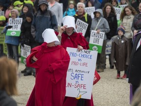 A small group of Pro Choice advocates walked through the crowd during the rally. About 1000 people gathered for The March for Life on the steps of the Alberta Legislature on May 10, 2018 before marching through the streets of downtown Edmonton with their Pro Life placards.