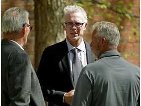 Former Edmonton Oiler hockey player Craig Mctavish (middle) leaves a memorial service for Brian Ross at Connelly-McKinley Funeral Home in Edmonton on Monday May 14, 2018.