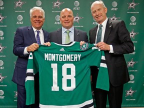 Dallas new head coach Jim Montgomery, centre, CEO Jim Lites, left, and general manager Jim Nill pose for a photograph during an NHL hockey press conference at American Airlines Center on May 4, 2018