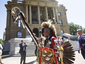 A procession makes its way into the Alberta legislature before Alberta Premier Rachel Notley apologizes to survivors and families of the Sixties Scoop in Edmonton on Monday, May 28, 2018.