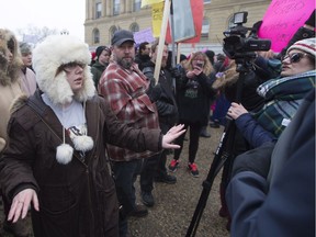 A participant in the Women's March steps in to try and calm the scene after The Rebel's Sheila Gunn Reid, right, was involved in an altercation with a man, in Edmonton, Alta., on Saturday Jan. 21, 2017.