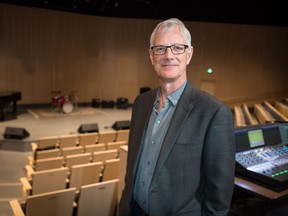 Music teacher standing in a theatre