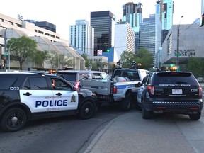 A stolen City of Edmonton truck damaged barricades, a parked car and a road sign before being intercepted by police in downtown Edmonton on Tuesday, May 15, 2018.