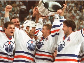 Wayne Gretzky, flanked by Mark Messier, left, and Kevin Lowe, celebrate the Edmonton Oilers' Stanley Cup victory in 1988.