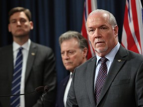 B.C. Premier John Horgan, Attorney General David Eby and Environment Minister George Heyman meet with media to discuss filing a court case regarding oil jurisdiction in B.C. in Victoria on Thursday April 26, 2018.