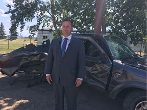 Staff Sgt. Sid Kingma of the cconomic crimes section stands in front of a Ford Ranger that was struck by a stolen Grand Prix was travelling westbound on 121 Avenue at 40 Street at a high speed on May 3. The female passenger of the Ford Ranger was ejected from the vehicle and then pinned under the truck, a news release said.