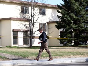 An Edmonton Police Service officer walks the streets near 87 Street and 96 Avenue on Monday, May 7, 2018, after police were called to area at about 3:40 p.m. in response to weapons complaint.