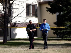 Edmonton Police Service officers walk the streets near 87 Street and 96 Avenue on Monday, May 7, 2018 after police were called to area at about 3:40 p.m. in response to weapons complaint. Police say a woman who was attacked by her estranged partner died.