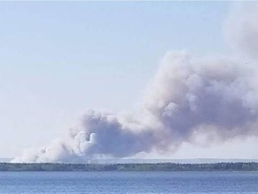 The Tuff fire, viewed from Waterhen Lake in central Saskatchewan on May 19, destroyed 13 cottages in the Flotten Lake subdivision over the weekend.