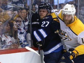 Winnipeg Jets forward Nikolaj Ehlers (left) is rubbed out by Nashville Predators defenceman Mattias Ekholm during Game 4 of their second-round NHL playoff series in Winnipeg on Thurs., May 3, 2018. Kevin King/Winnipeg Sun/Postmedia Network