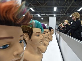 People photograph the finished hair styles from competitors in the hairstyling competition as more than 550 youth competitors from across the country compete in the Skills Canada National Competition at the Expo Centre in Edmonton on Monday, June 4, 2018.