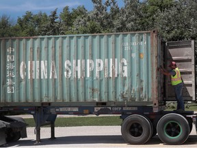 Dakota Jones loads soybeans into a shipping container at a Ruff Bros. Grain elevator on June 13, 2018 in Blackstone, Illinois.