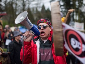 Cedar George-Parker addresses the crowd as protesters opposed to the Kinder Morgan Trans Mountain pipeline extension defy a court order and block an entrance to the company's property, in Burnaby, B.C., on Saturday April 7, 2018.