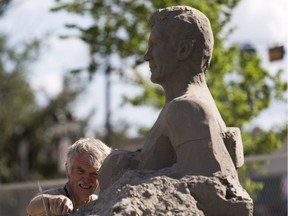 Sand sculpture artist Peter Vogelaar works on his sculpture  of Mayor Don Iveson for "Intentional Beach" at the corner of Whyte Avenue and Gateway Blvd, opening on June 29, 2018.