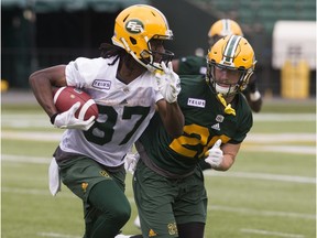 Derek Walker (87) and Jordan Hoover (28) take part in an Edmonton Eskimos practice at Commonwealth Stadium, in Edmonton Monday June 4, 2018.