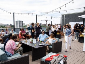 People enjoy the rooftop patio during Moet & Chandon Grand Day at the Crawford Block Annex Building in Edmonton on Saturday, June 9, 2018.