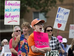 Protestors call on the Canadian government to pressure the U.S. to stop child detentions, stop criminalizing asylum seekers, and end the Safe Third Country Agreement during a rally at End of Steel Park, 8720 104 Street, in Edmonton Saturday June 30, 2018. Photo by David Bloom