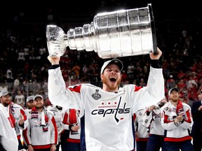 John Carlson of the Washington Capitals hoists the Stanley Cup after his team defeated the Vegas Golden Knights 4-3 in Game Five of the 2018 NHL Stanley Cup Final at T-Mobile Arena on June 7, 2018 in Las Vegas, Nevada.
