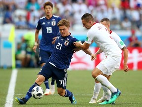 Gotoku Sakai of Japan is challenged by Artur Jedrzejczyk of Poland during the 2018 FIFA World Cup Russia group H match between Japan and Poland at Volgograd Arena on June 28, 2018 in Volgograd, Russia.