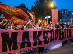 Demonstrators wave flags in front of the parliament building in Skopje on June 13, 2018 during a protest against the new name of the country. Greeks and Macedonians expressed scepticism on June 13 over a proposed compromise deal to end a nearly three-decade name row between their countries which has blocked Skopje's bid to join the EU and NATO. The leaders of the neighbouring countries hailed a "historic" agreement on June 12 to rename the tiny Balkan nation the Republic of North Macedonia after months of intensive talks.