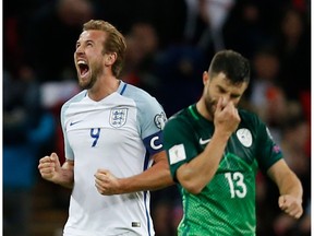 England's striker Harry Kane (L) celebrates their 1-0 victory at the end of the FIFA World Cup 2018 qualification football match between England and Slovenia at Wembley Stadium in London on October 5, 2017.
