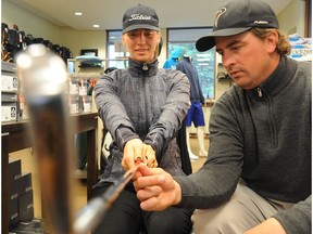 Cam Martens goes over hand grip with golfer Kristen Monasterski.