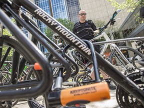 A volunteer looks at the bikes up for sale during The Edmonton Bike Swap at the Kinsmen Sport Centre in Edmonton on Saturday, May 12, 2018. Police say nearly 600 bikes have been reported stolen in the city so far this year.