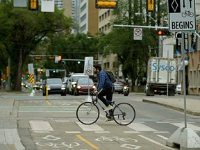 A cyclist on 100 Avenue near 109 Street in downtown Edmonton on Tuesday June 26, 2018. (PHOTO BY LARRY WONG/POSTMEDIA)