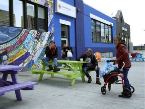 Clients outside Boyle Street Community Services in Edmonton on June 14, 2018 where a pilot project that includes wall art, chairs and picnic tables will become permanent.