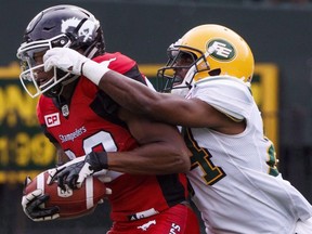 Calgary Stampeders Kamar Jorden (88) is tackled by Edmonton Eskimos Brandyn Thompson (24) during first half CFL pre-season action in Edmonton, Alta., on Sunday June 11, 2017.