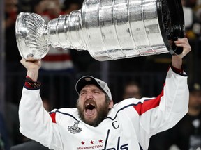 Alex Ovechkin of the Washington Capitals holds the Stanley Cup aloft following their 4-3 win over the Vegas Golden Knights in Game 5 of the Stanley Cup final Thursday night in Las Vegas. By virtue of the victory, the Caps won the series 4-1. Ovechkin also won the Conn Smythe Trophy as playoff MVP.